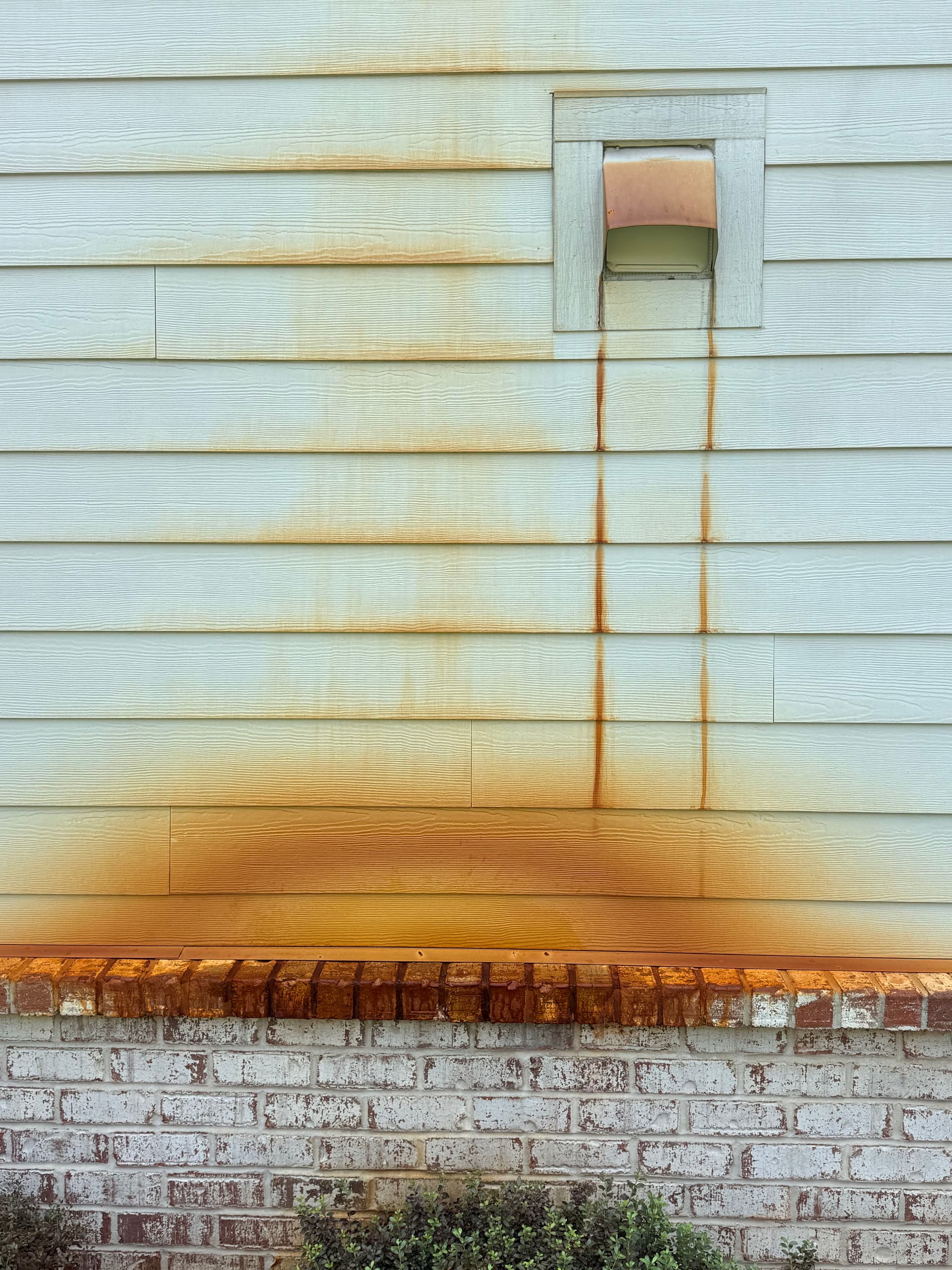 Rust Stain Removal on Home Siding - Before and After image