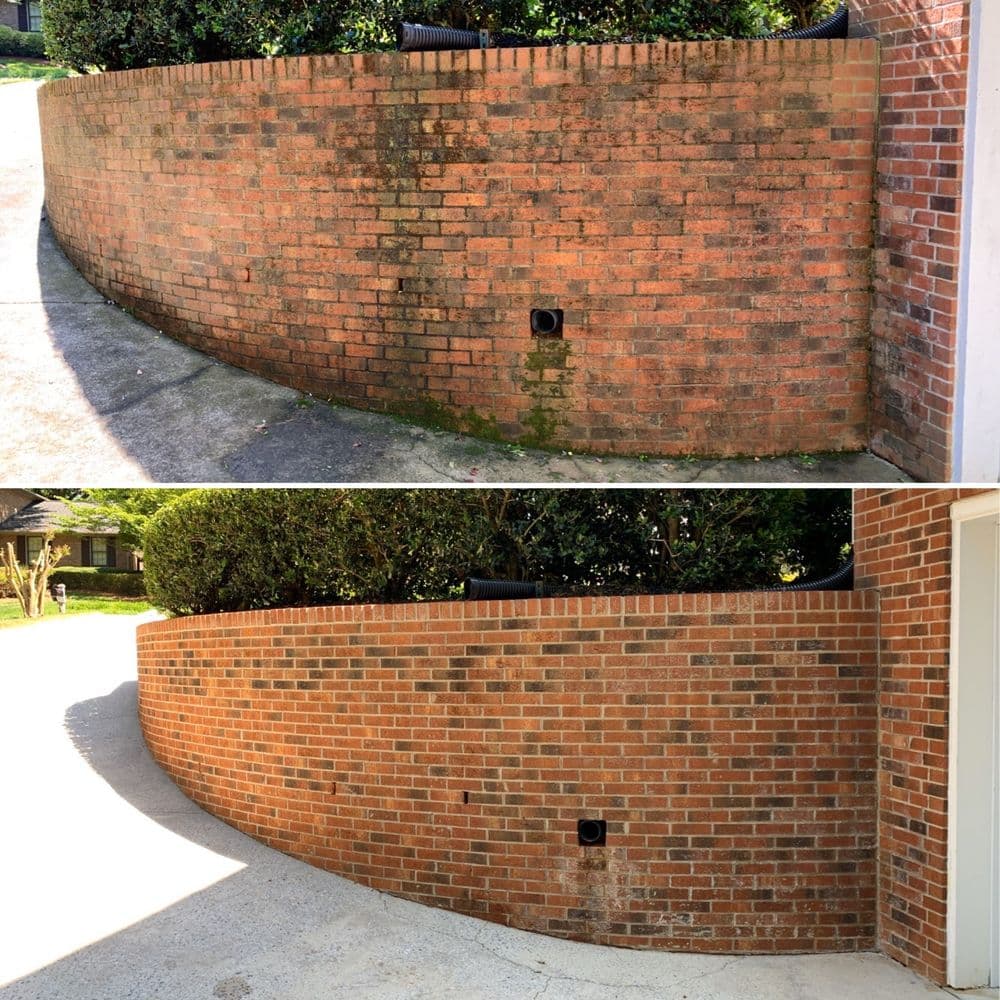 Before and after comparison of a cleaned red brick fence showing improved appearance.